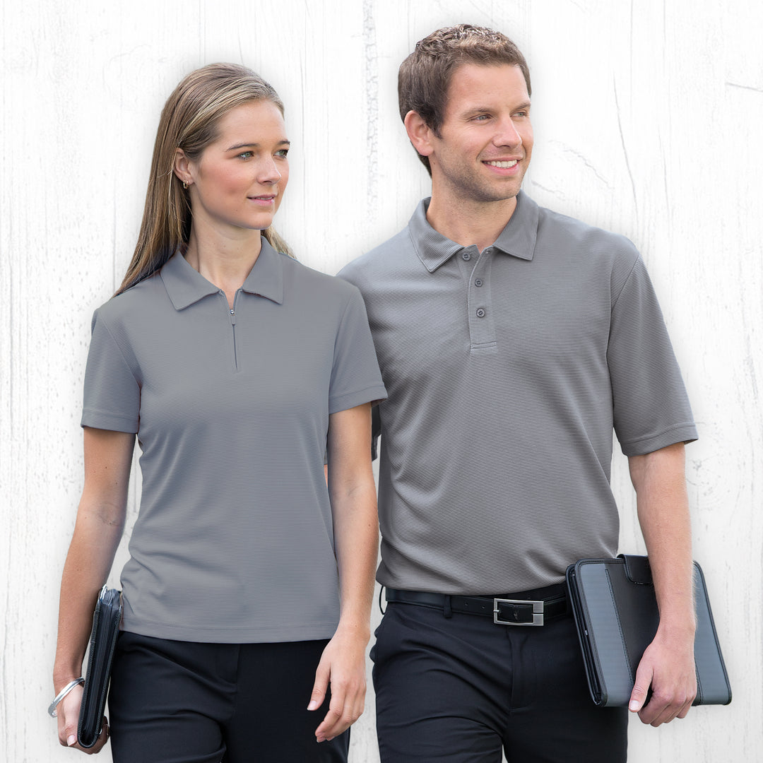 Man and woman wearing Gear for Life Men's Dri Gear Ottoman Lite Polo - DGOL